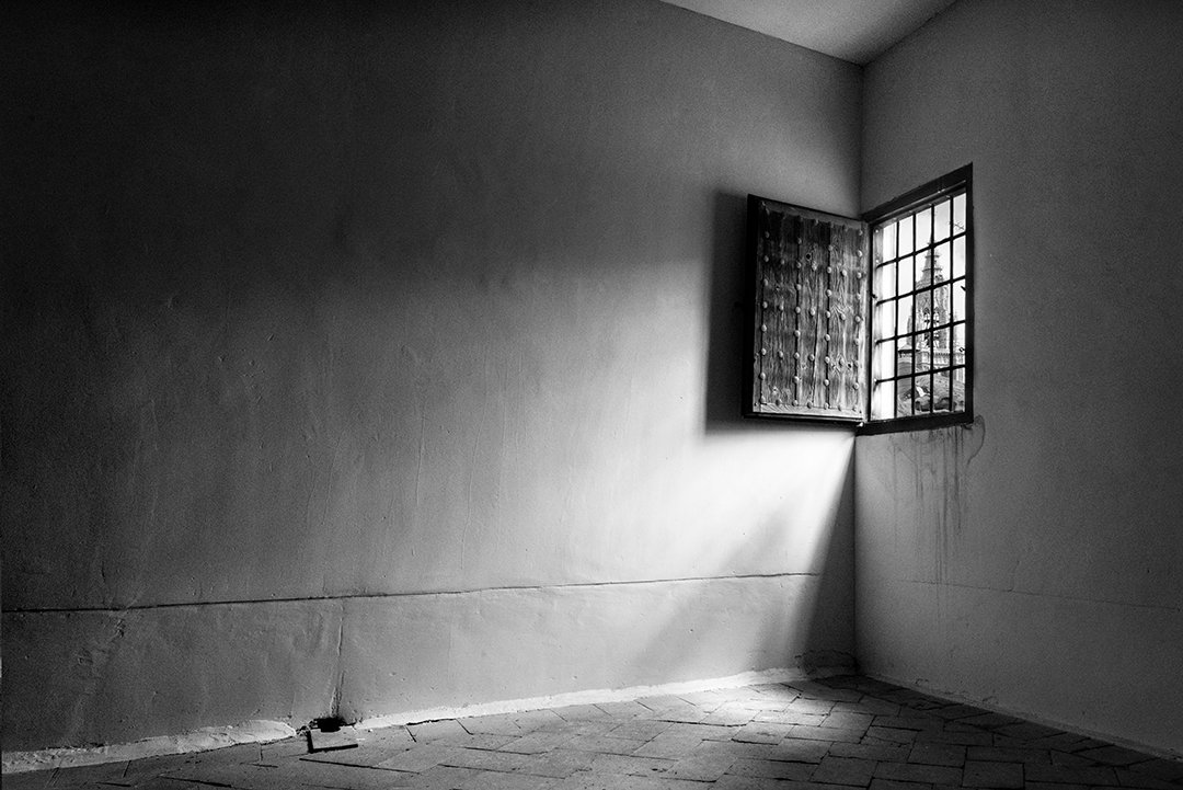 Window light on an empty wall and floor.